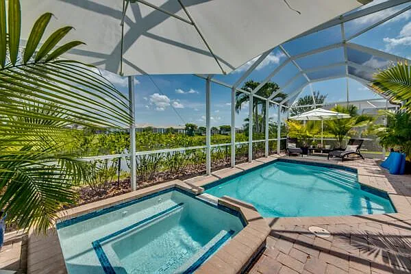 Private screened pool and spa with lake views at 2649 Casibari Ct, Sandoval, Cape Coral